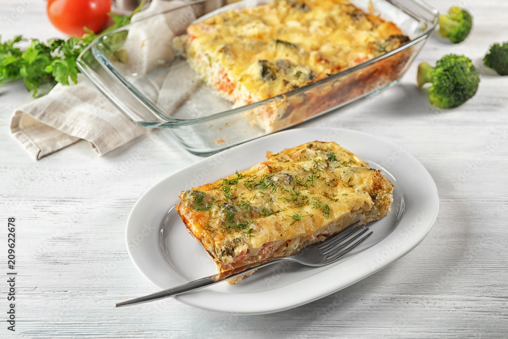 Plate with tasty broccoli casserole on table. Fresh from oven