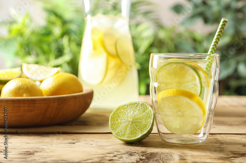 Natural lemonade with lime in glass on table photo