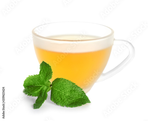 Cup with hot aromatic mint tea on white background