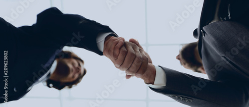 Two business people are holding hands to business cooperation. photo