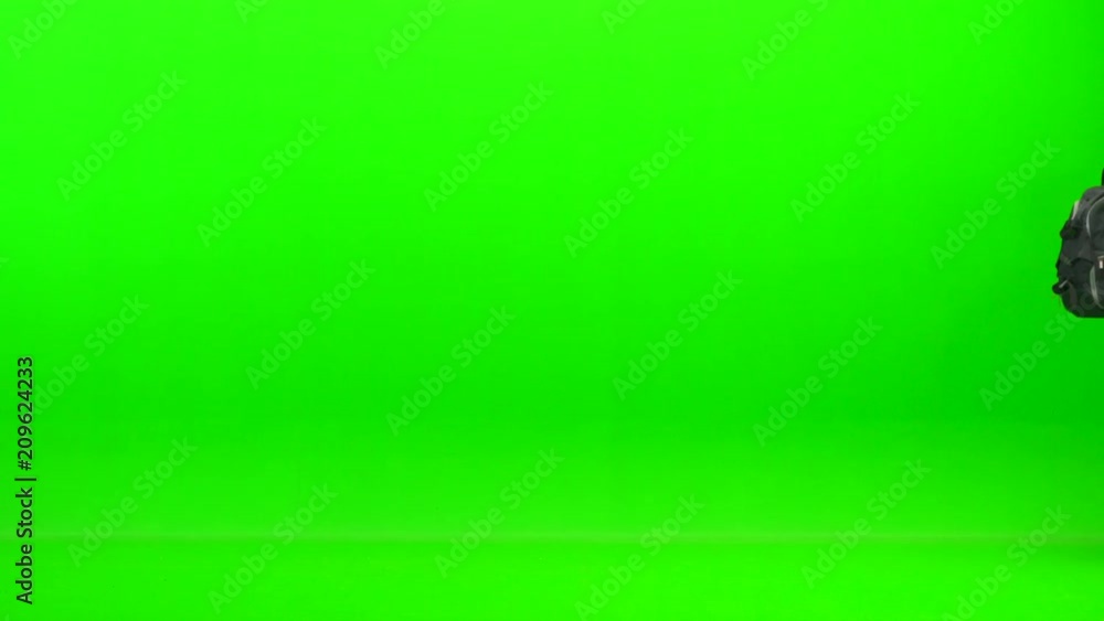 The man walking with a backpack on the green background The man walking with a backpack on the green background