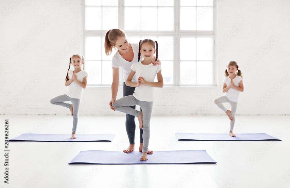 children practicing engaged in gymnastics and yoga with teacher children practicing engaged in gymnastics and yoga with teacher