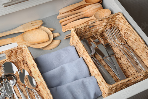Obraz na plátně Set of cutlery and wooden utensils in opened kitchen drawer