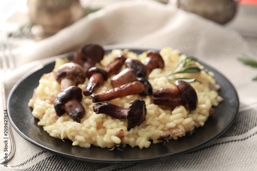 Plate with tasty risotto and mushrooms on table Plate with tasty risotto and mushrooms on table