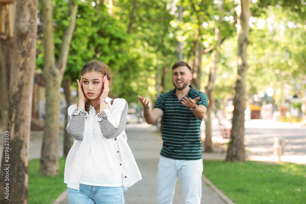 Young couple arguing on street. Problems in relationship Young couple arguing on street. Problems in relationship