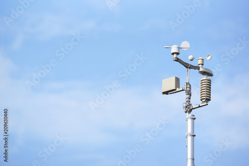 Weather station on blue sky background