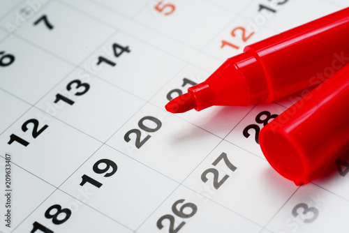 a red maker pen on the calendar 
