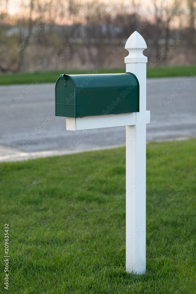 Green Mailbox on Grass Lawn