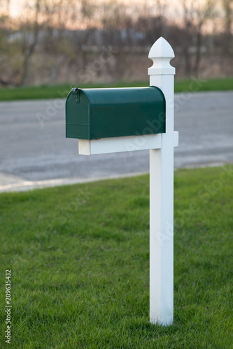 Green Mailbox on Grass Lawn  photo