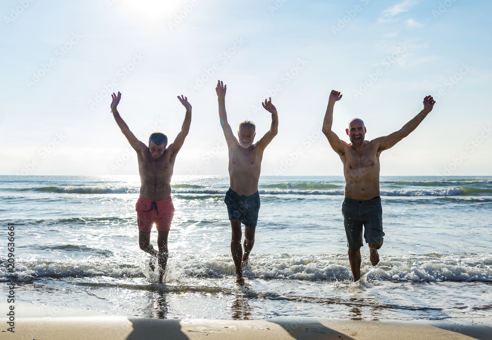 Senior friends enjoying the beach in the summertime Senior friends enjoying the beach in the summertime