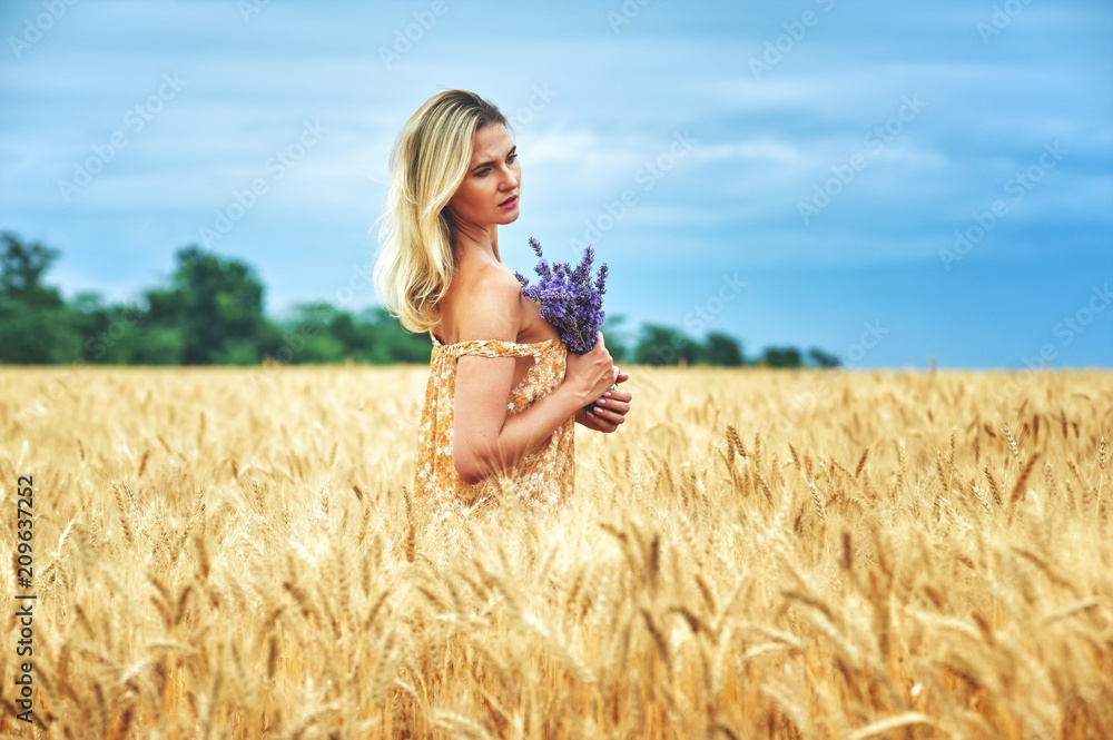 Young romantic woman in a wheat field Young romantic woman in a wheat field