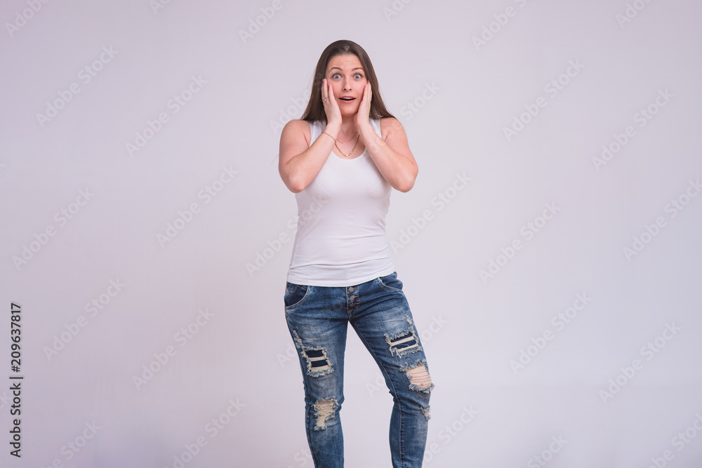 portrait of a beautiful brunette girl on a white background in different poses with different emotions. portrait of a beautiful brunette girl on a white background in different poses with different emotions.