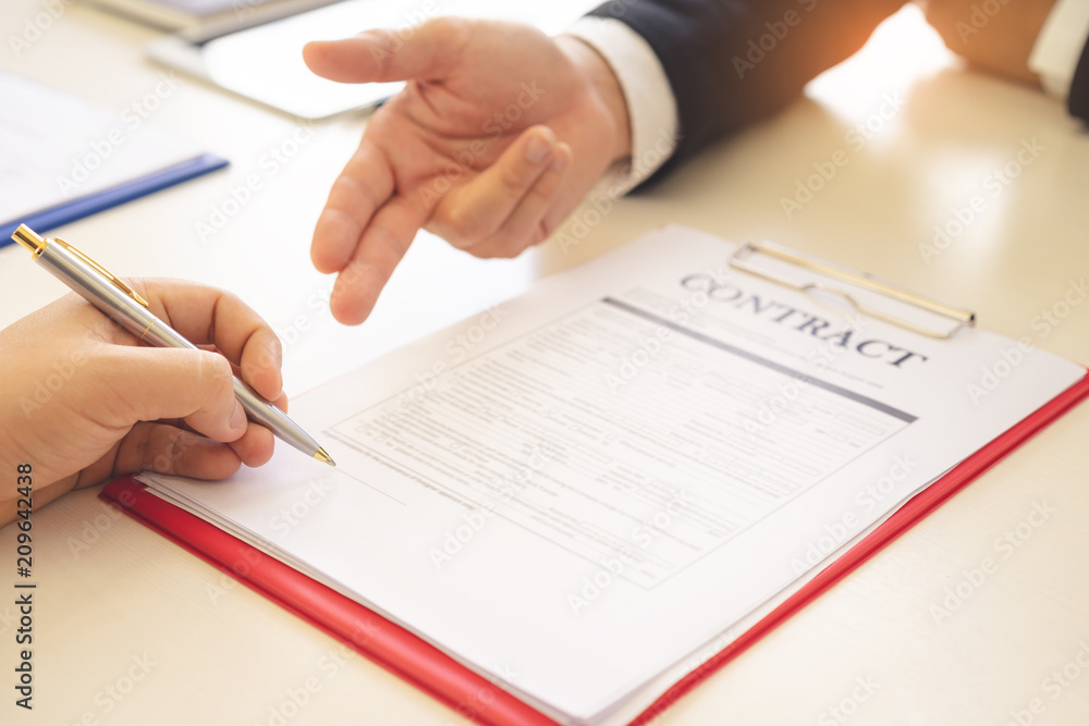 Businessman hands are pointing at the line needs autograph and man signing contract. Businessman hands are pointing at the line needs autograph and man signing contract.