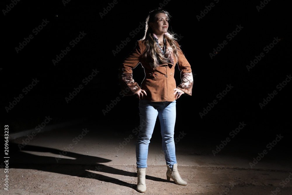 Ugly woman on night street and light behind her Ugly woman on night street and light behind her
