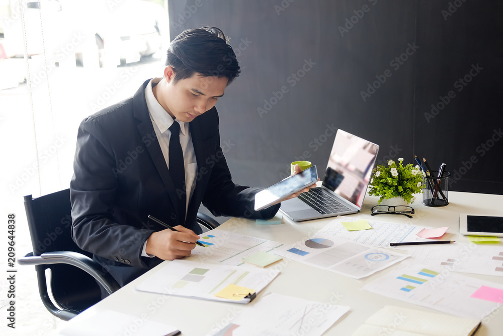 Asian businessman on workplace in office. Asian businessman on workplace in office.