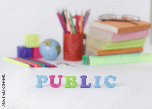 word public on blurred background of school supplies .photo with copy space