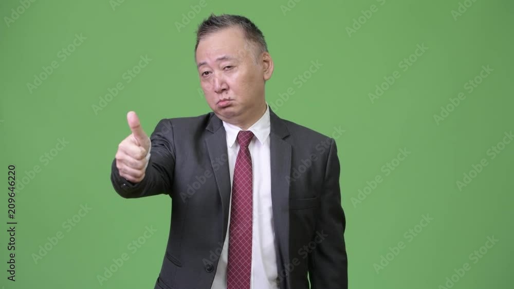 Mature Japanese businessman giving thumbs up Mature Japanese businessman giving thumbs up