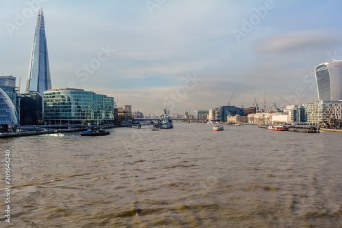 View on London and Thames from Tower Bridge  with Shard  20 Fenchurch Street and several boats in the water.