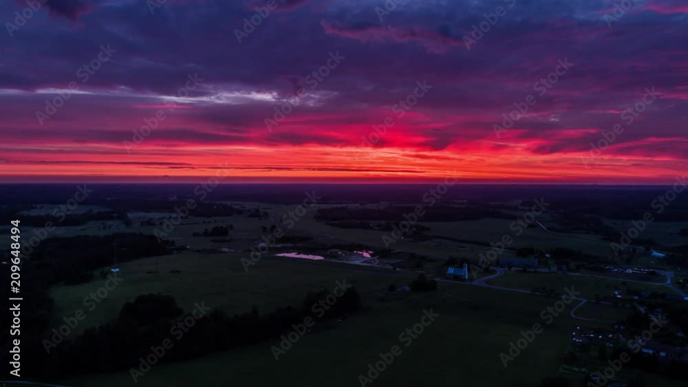 Aerial view of green fields with clouds above at sunset. Drone sunset timelapse footage. Summer nature landscape. Aerial view of green fields with clouds above at sunset. Drone sunset timelapse footage. Summer nature landscape.