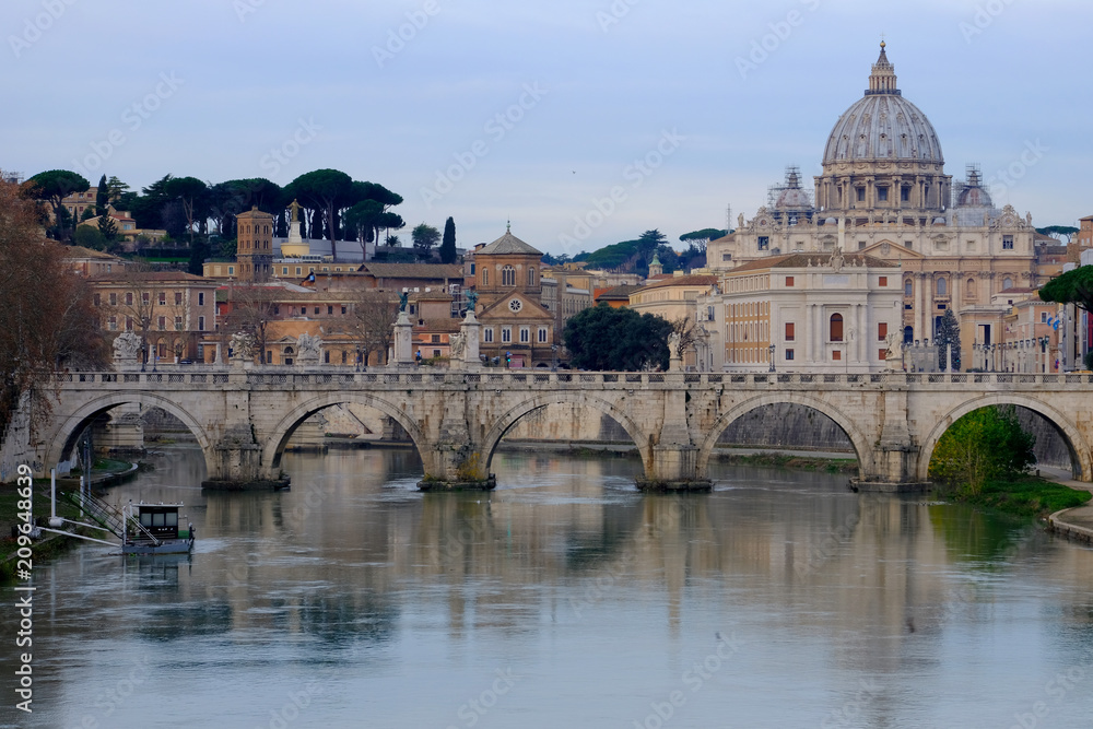Rome, Italy. Vatican dome of Saint Peter Basilica San Pietro and Sant'Angelo Eliev Bridge, over Tiber river. Dawn sunset time Cityscape