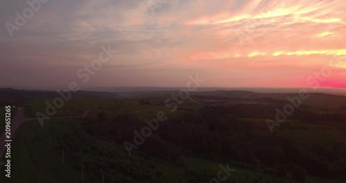 Wallpaper Mural AERIAL view. long and winding road passing through green hills with countryside scenery at sunset. 4K Torontodigital.ca