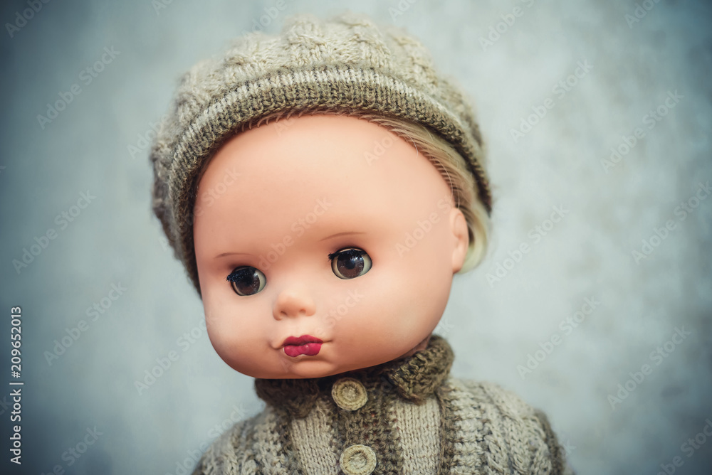 Old doll in knitted clothes closeup Old doll in knitted clothes closeup