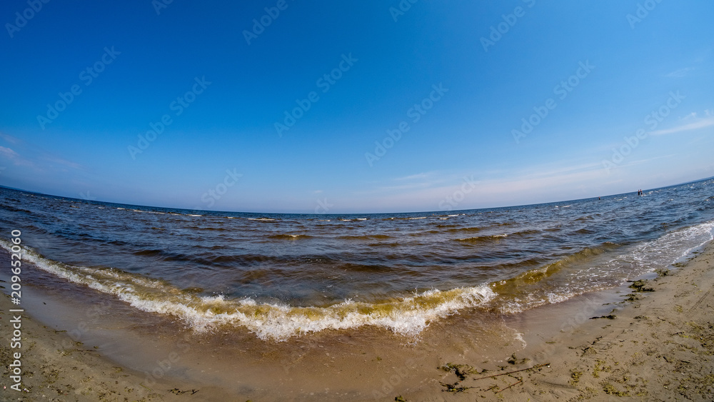 Summer sea, beach and clear blue sky. Concept of relaxation