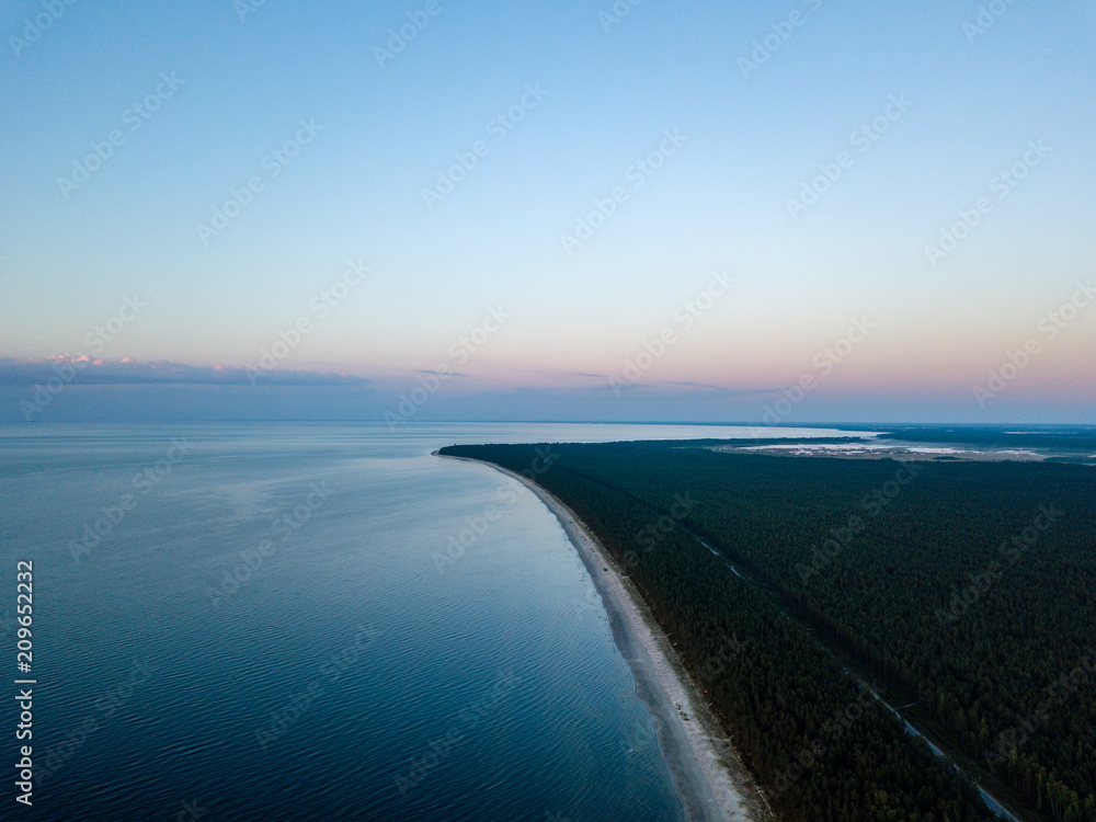Fototapeta drone image. aerial view of red sunset in the sea. shore line