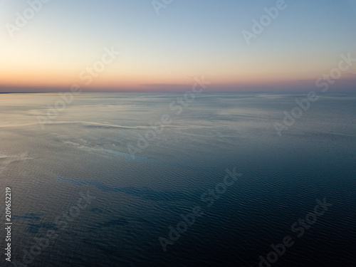 drone image. aerial view of red sunset in the sea. shore line