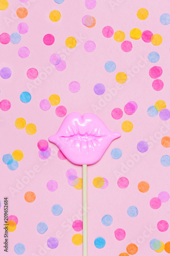 Creative confetti background vith pink lips photo