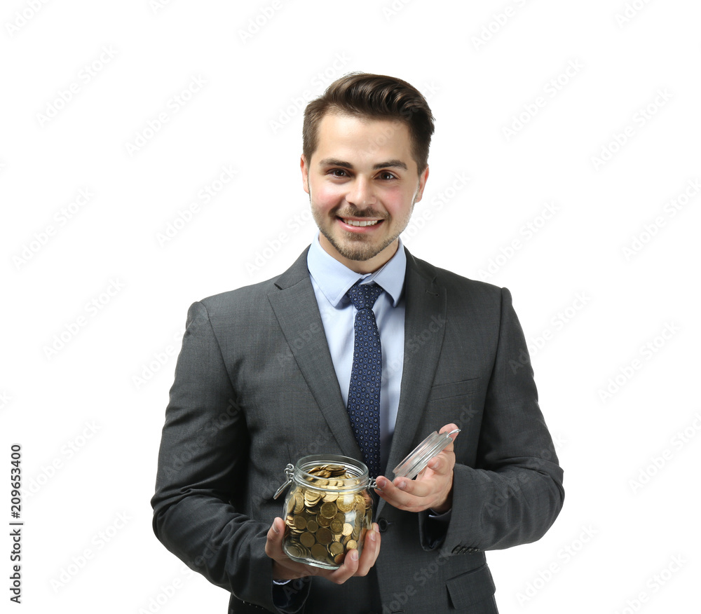 Young businessman holding glass jar with coins on white background. Savings money concept Young businessman holding glass jar with coins on white background. Savings money concept