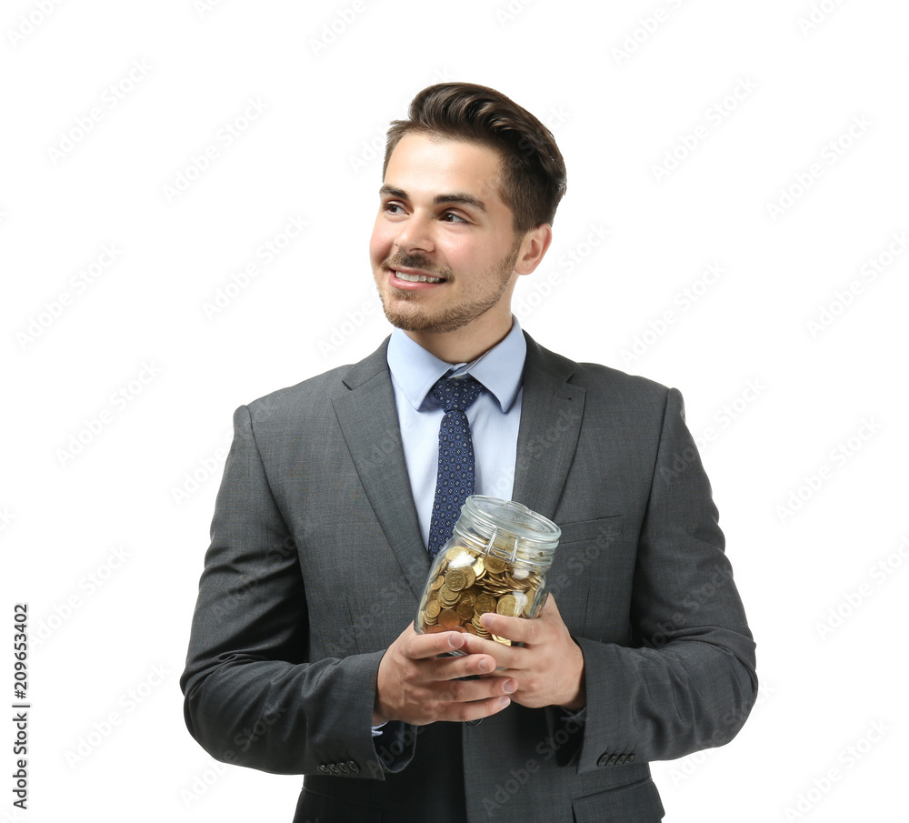 Young businessman holding glass jar with coins on white background. Savings money concept Young businessman holding glass jar with coins on white background. Savings money concept