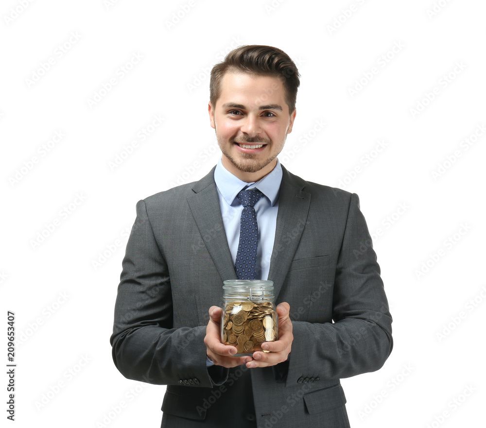 Young businessman holding glass jar with coins on white background. Savings money concept Young businessman holding glass jar with coins on white background. Savings money concept