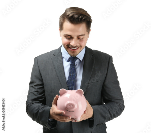 Young businessman holding piggy bank on white background. Savings money concept