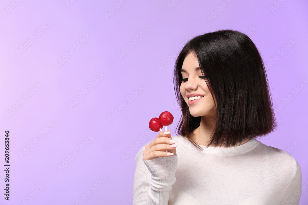 Beautiful young woman with lollipops on color background Beautiful young woman with lollipops on color background