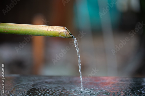 The water rinse from bamboo pipe of temple.