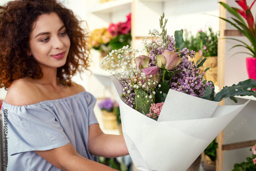 Beautiful flowers. Selective focus of a beautiful bouquet being held by a positive cheerful woman Beautiful flowers. Selective focus of a beautiful bouquet being held by a positive cheerful woman
