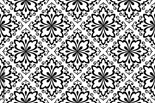 Wallpaper in the style of Baroque. A seamless vector background. White and black floral ornament. Graphic pattern for fabric, wallpaper, packaging. Ornate Damask flower ornament