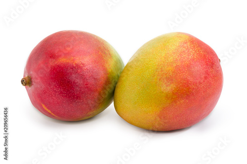 Two whole mango fruit on a white background
