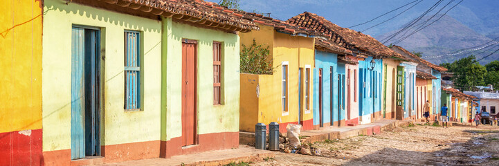 Fototapete Karibik Panorama von bunten Häusern in einer gepflasterten Straße von Trinidad, Kuba  © Delphotostock