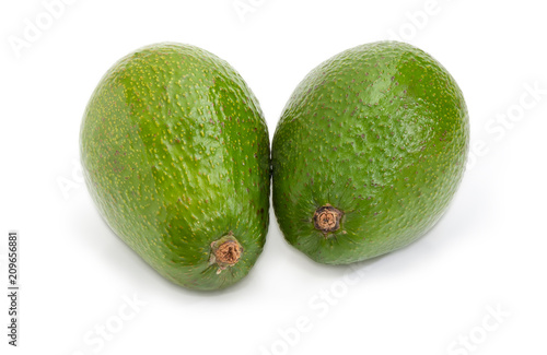 Two whole green-skinned avocado fruits on a white background