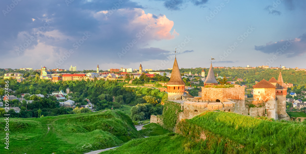 View of Kamianets-Podilskyi with old fortress at sunset, Ukraine