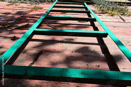 Wallpaper Mural A long green garden staircase on a red wooden pallet in the garden, home construction work in the yard. In the summer sunlight with shadows under a tree. Torontodigital.ca