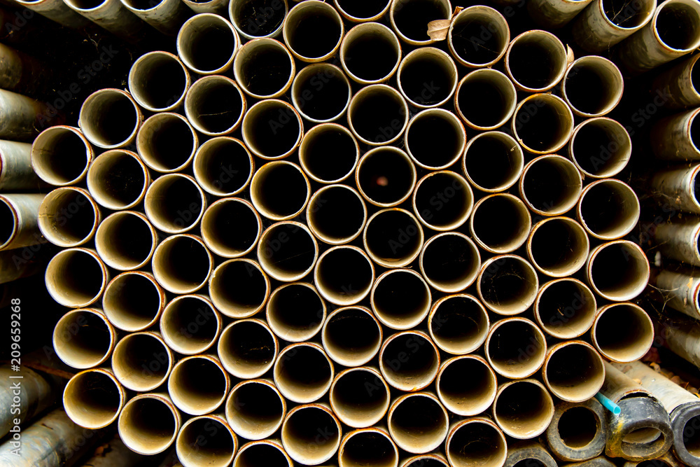 Old stainless steel pipes in stacks. Old stainless steel pipes in stacks.