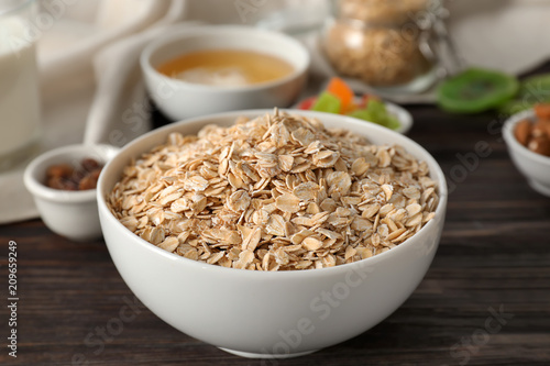 Bowl with raw oatmeal on table