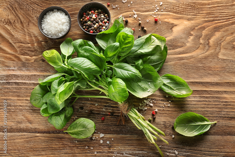 Fresh basil with spices on wooden table Fresh basil with spices on wooden table