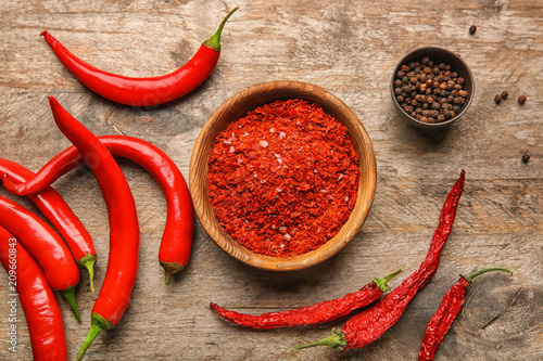 Composition with chili pepper on wooden background