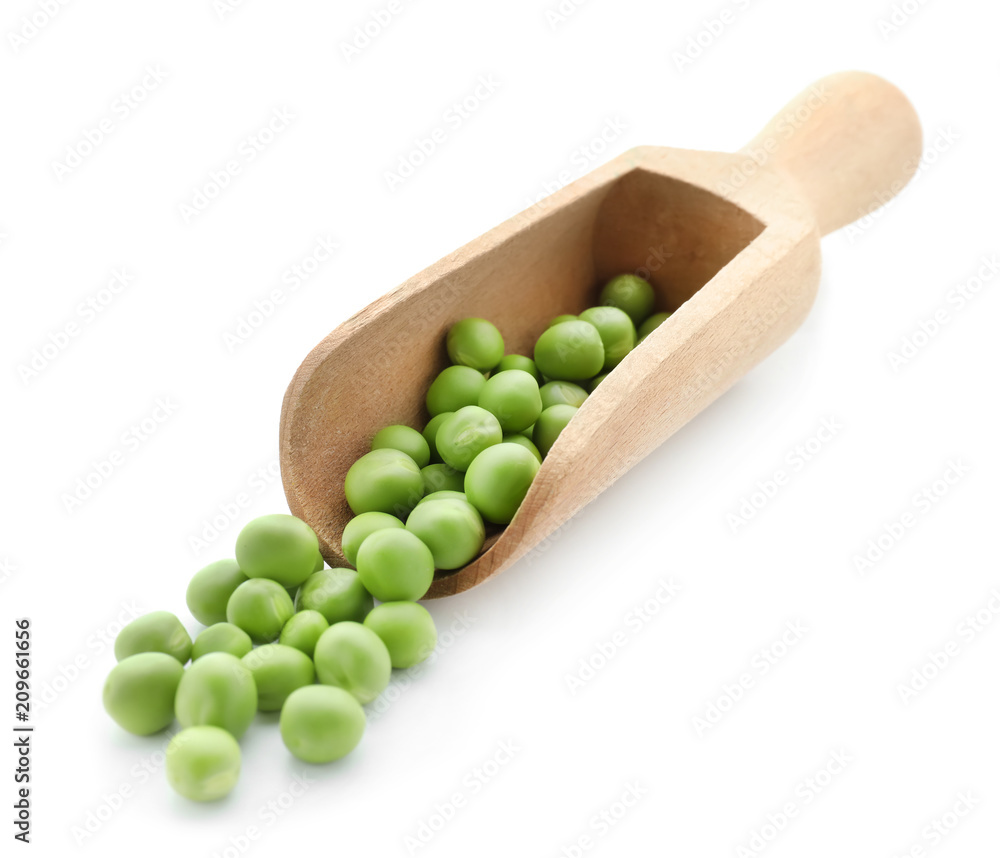 Scoop with fresh green peas on white background Scoop with fresh green peas on white background