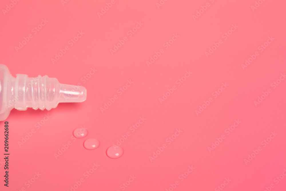 Eye drops isolated on pink background