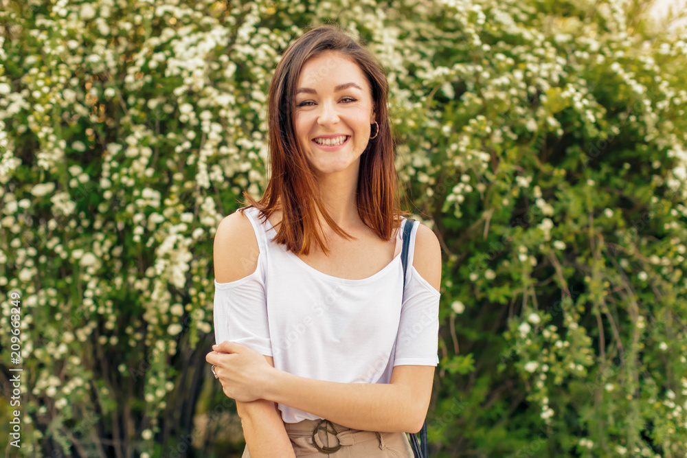 Portrait of a young attractive woman in a street on a sunny day Portrait of a young attractive woman in a street on a sunny day